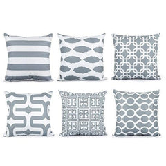 Six grey and white cushion covers with stripes and interlocking geometric patterns.