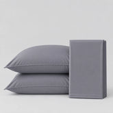 Two gray pillowcases stacked on the left and a folded matching gray pillowcase on the right, photographed on a clean light gray studio background.