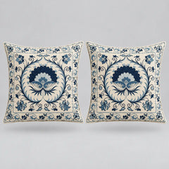 Two square decorative throw pillows with a blue and cream floral damask pattern, displayed side-by-side against a neutral light gray background.