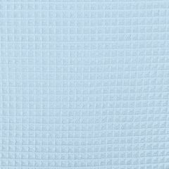 A close-up of a light blue textured fabric with a repeating waffle or embossed grid pattern.