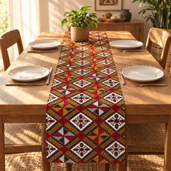 Red, yellow, black and cream geometric table runner along a dining table set with plates