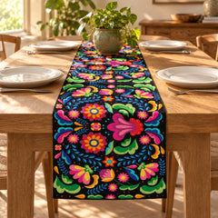 Black table runner densely patterned with bright multicoloured flowers.