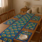 Blue table runner with green and yellow circular motifs and matching placemats.