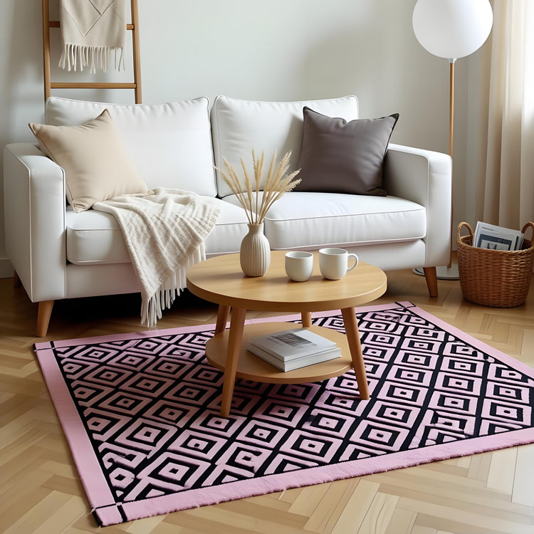 Black and tea pink diamond-pattern rug displayed in a living room.