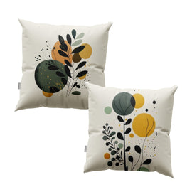 Two cream cushion covers with black leafy stems over green and mustard circles.