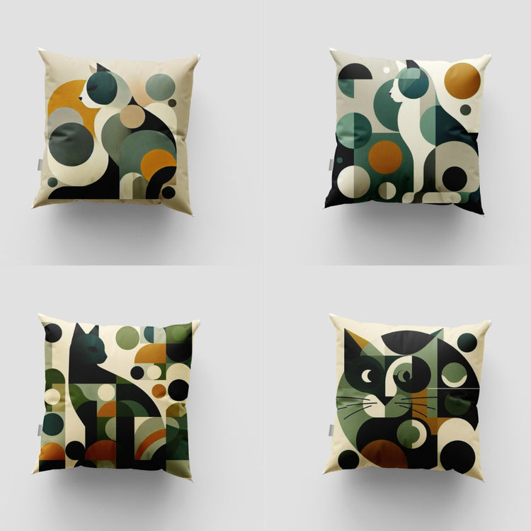 Four cream cushion covers with green, black and mustard geometric cat illustrations.