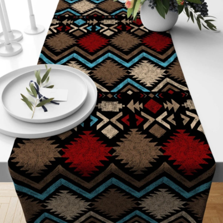Black table runner with red and turquoise geometric bands.