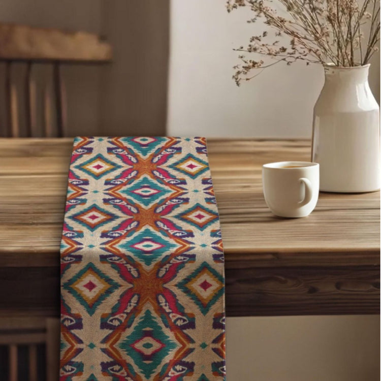 Multicoloured diamond-pattern table runner draped over a wooden table.