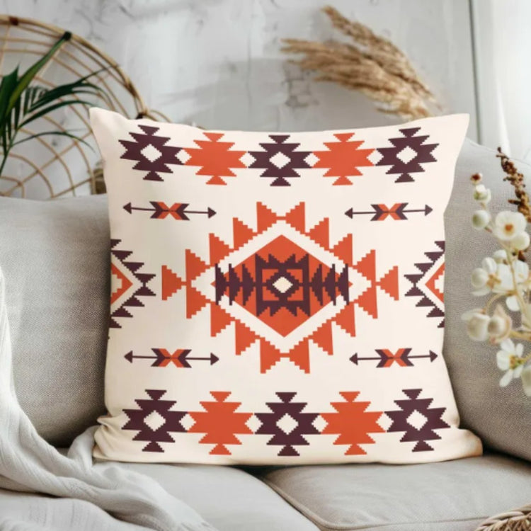 Cream cushion cover with rust and brown stepped diamonds and small geometric shapes.