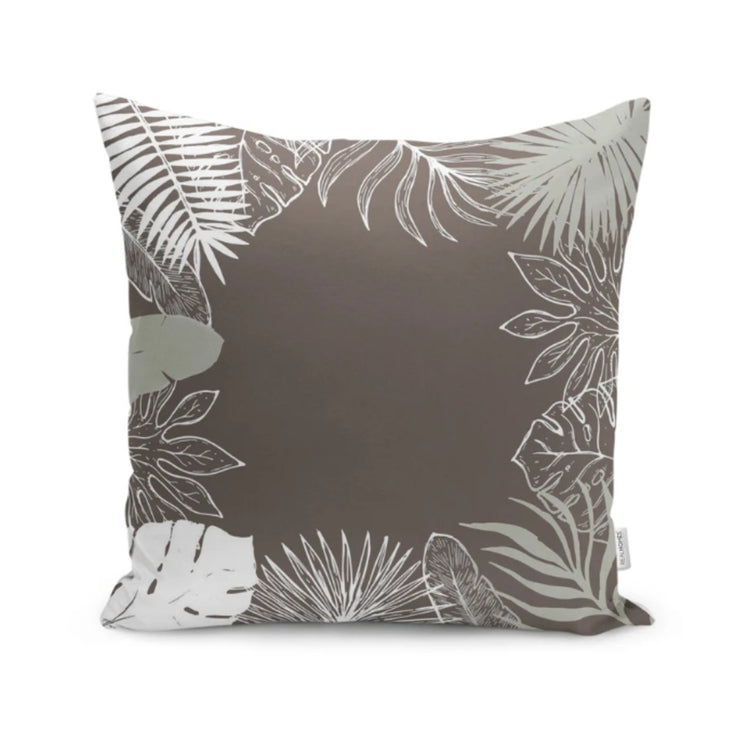 Dark taupe cushion cover with pale tropical leaf outlines framing the edges.