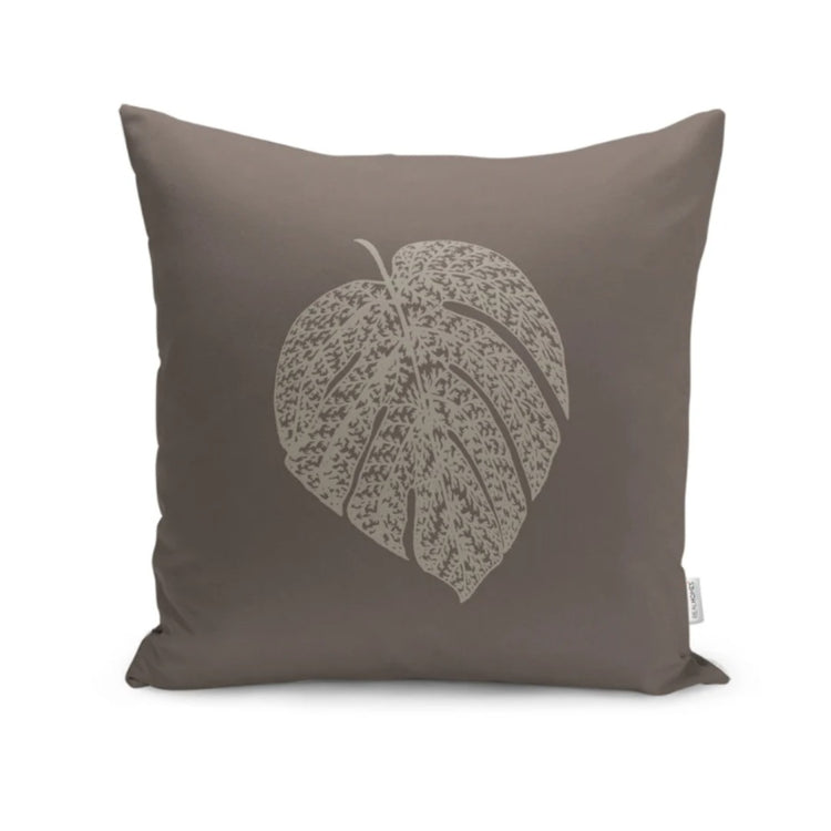 Taupe cushion cover with a large pale leaf illustration in the centre.