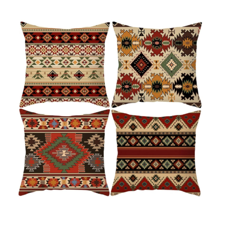 Four cream, rust, mustard and black cushion covers with intricate geometric patterns.