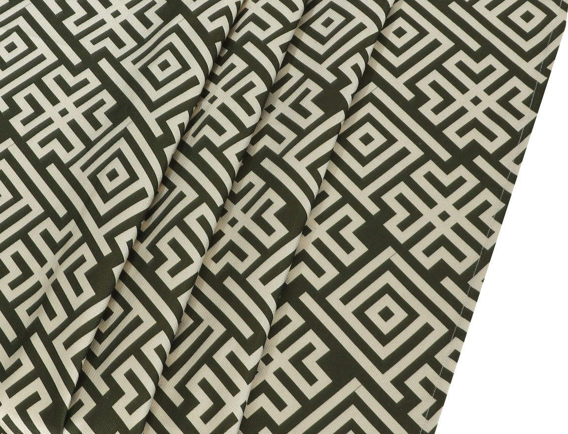 Close-up of the dark green geometric pattern on a cream tablecloth.