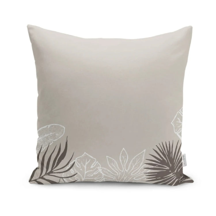 Cream cushion cover with grey and pale leaf outlines along the bottom edge.