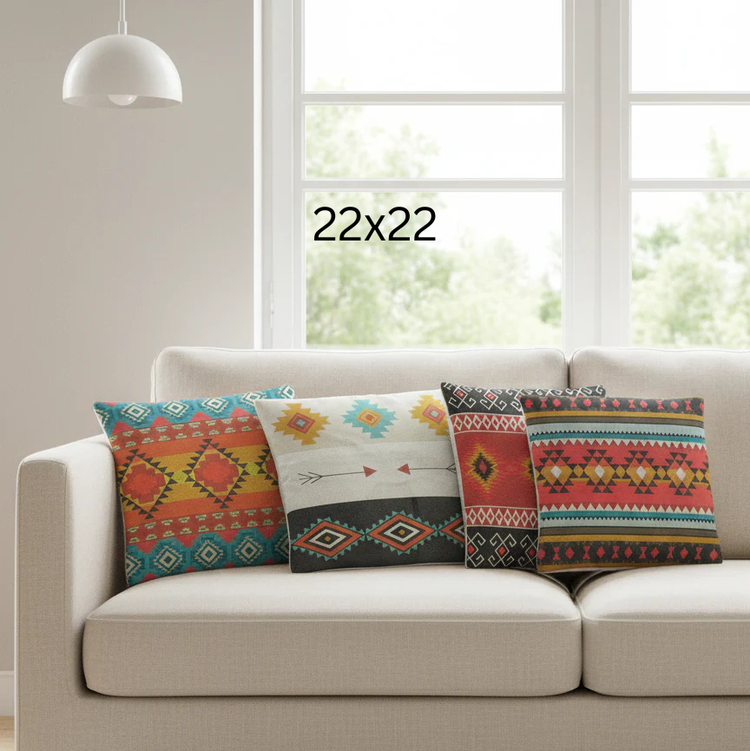 Three colourful geometric cushion covers on a sofa with a 22 by 22 size label.