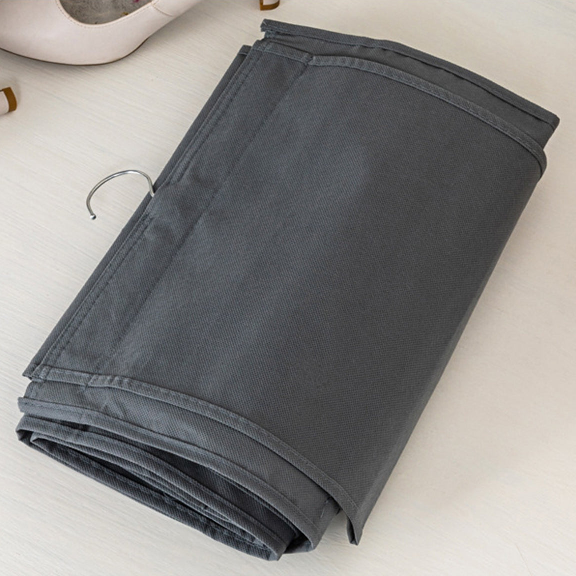 Grey fabric shoe organizer folded flat for storage.