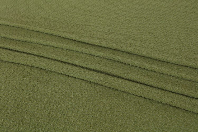 Close-up of olive green cotton thermal blanket fabric.