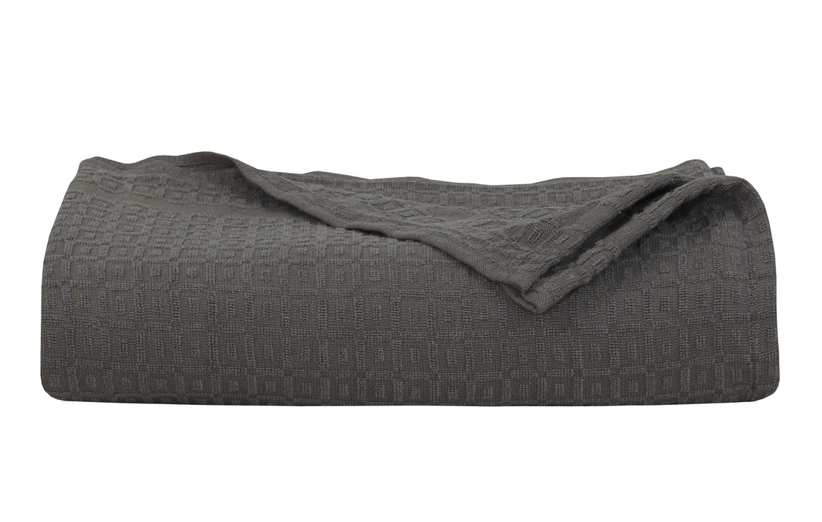 Folded charcoal grey cotton thermal blanket.