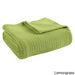 Folded lime green ribbed cotton thermal blanket.
