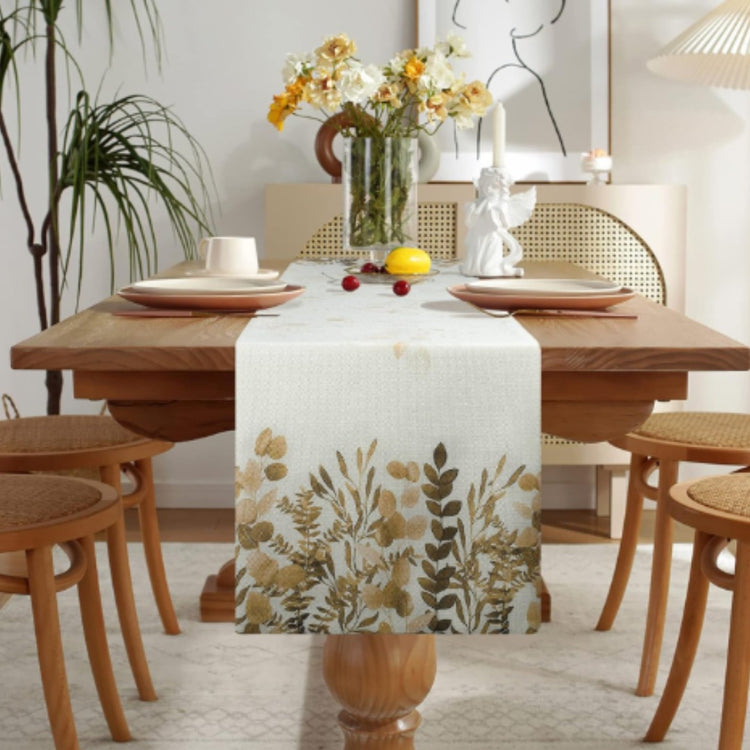 Cream table runner with delicate brown and green botanical branches.