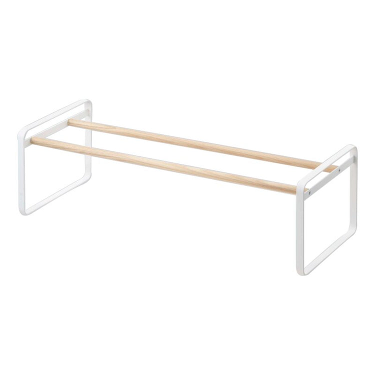 Empty low white shoe rack with two wood-tone rails