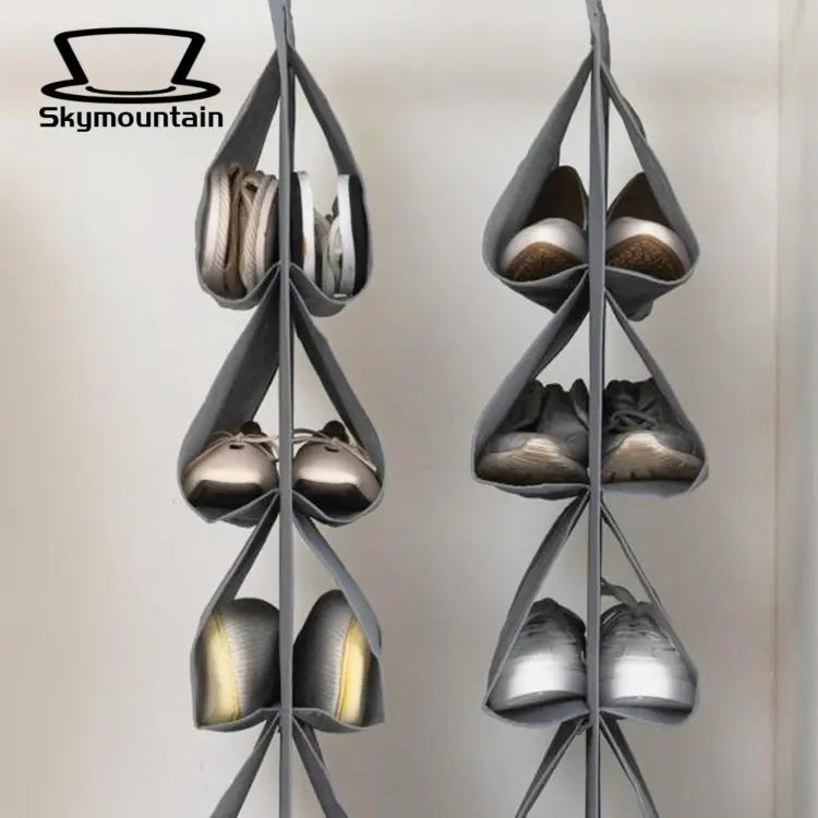Two dark hanging shoe organizers displaying shoes in individual pockets.