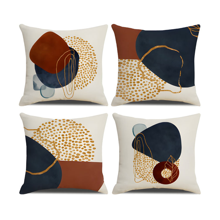 Four cushion covers with navy and rust shapes, gold coloured dots and fine looping lines.