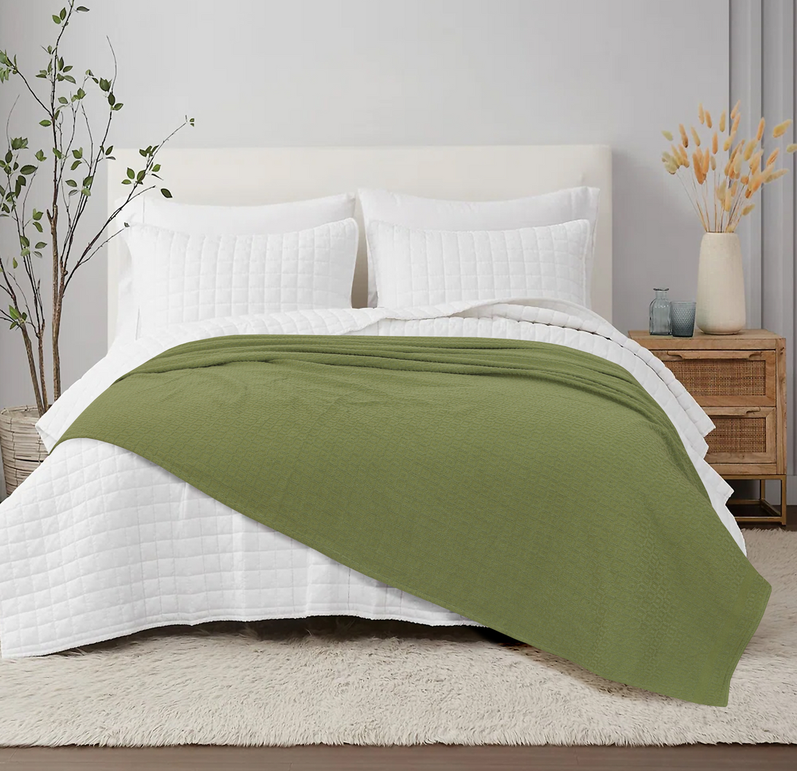 Olive green cotton thermal blanket spread across a bed.