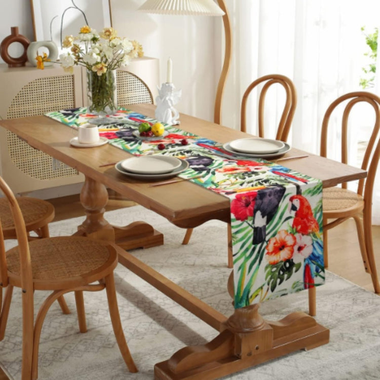 Colourful tropical floral table runner on a wooden dining table.