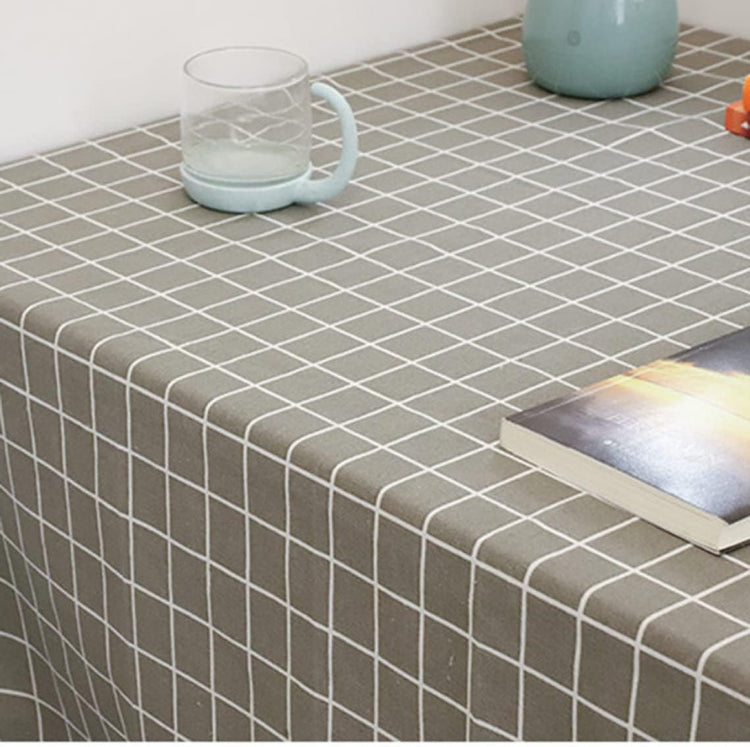 Close-up of a grey tablecloth with a white grid pattern.