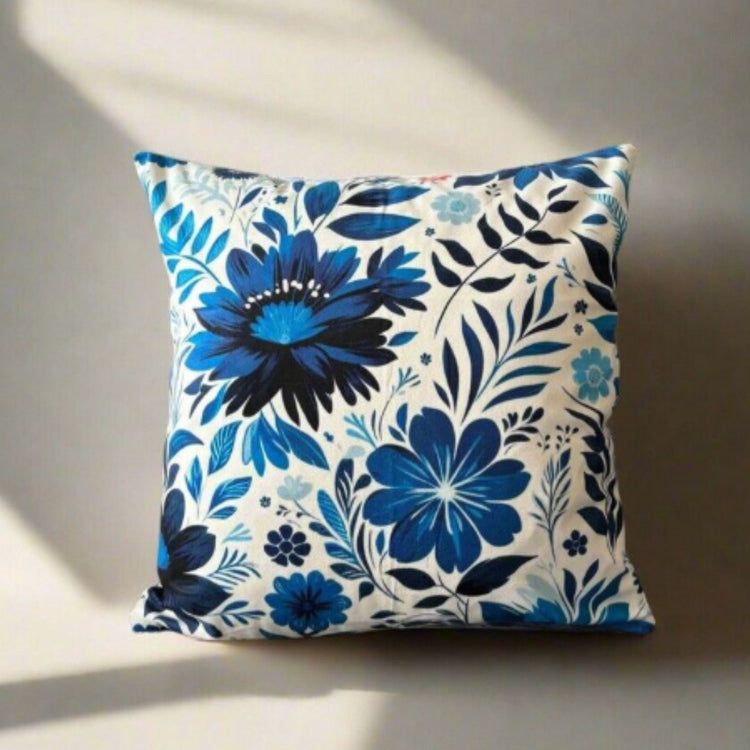 Cream cushion cover with large blue flowers and detailed blue leaves.