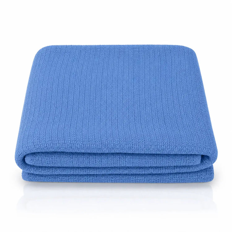Folded blue ribbed blanket showing its layered edges.