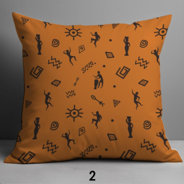 Orange cushion cover with small black figures, suns and geometric symbols.