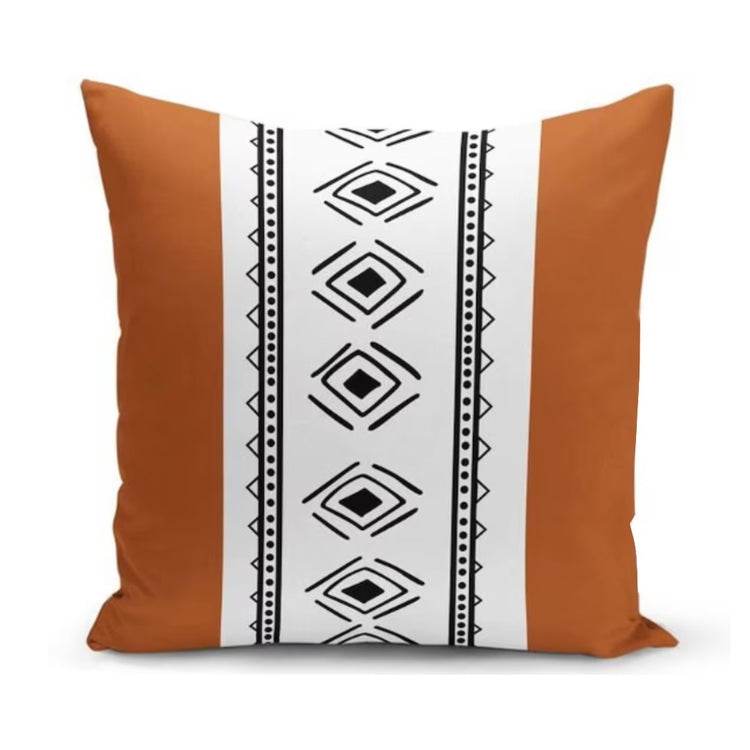 Cushion cover with rust side panels and a central white band of black diamonds.