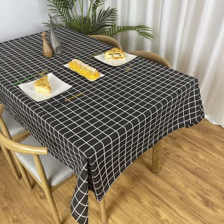 Black tablecloth with a white grid pattern on a dining table.