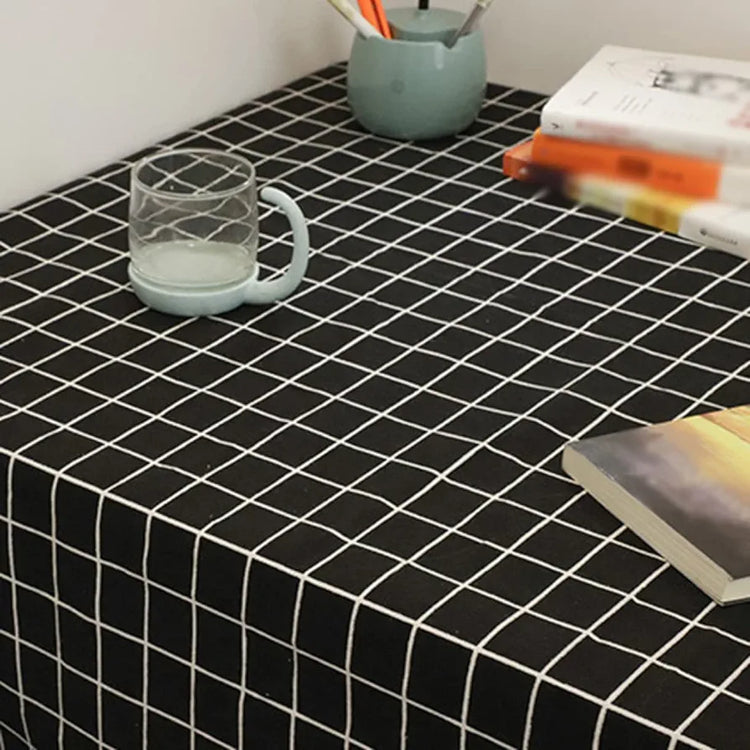 Close-up of a black tablecloth with a white grid pattern.