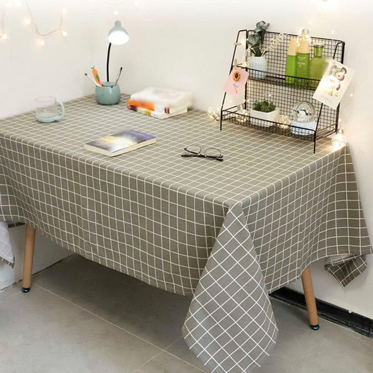 Grey tablecloth with a white grid pattern on a table.