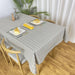 Light grey grid-pattern tablecloth covering a dining table.