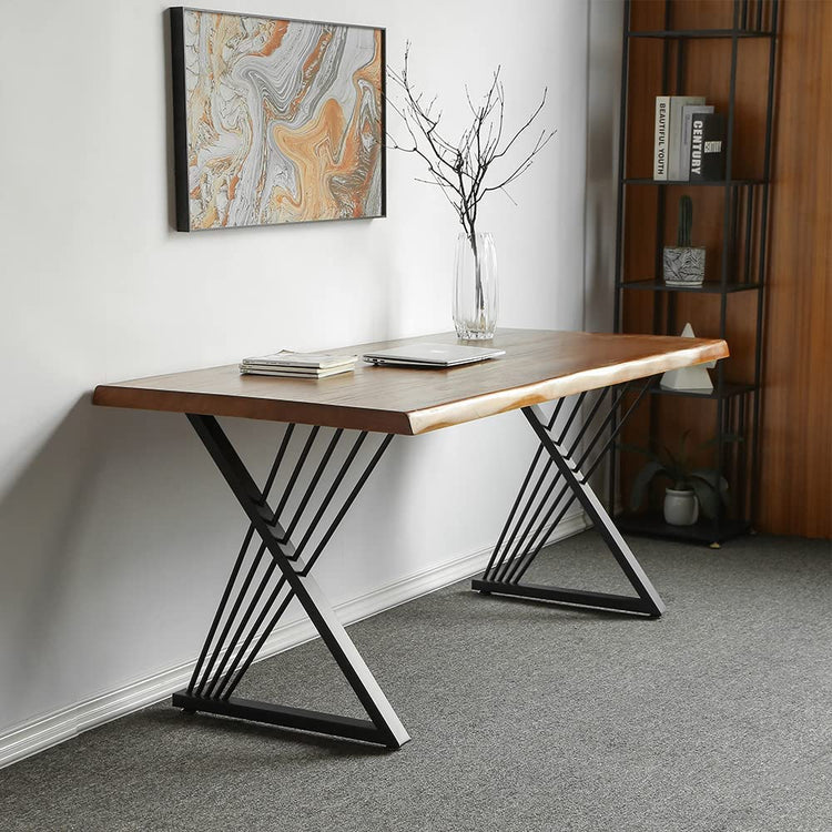 Brown-top desk with black crossed leg supports against a wall beneath abstract artwork.