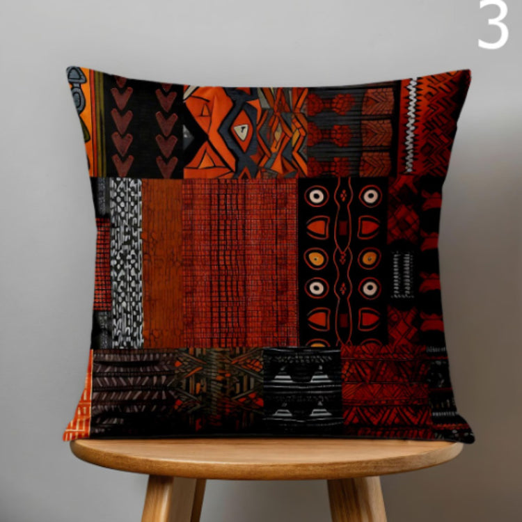 Dark cushion cover with rust and black textured geometric patchwork panels.
