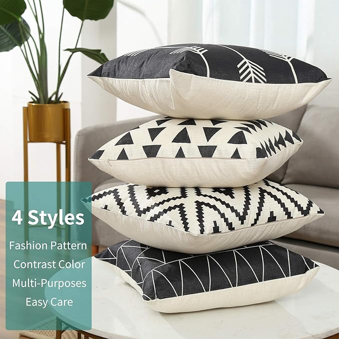 Stack of four black and white cushion covers showing their different geometric patterns.