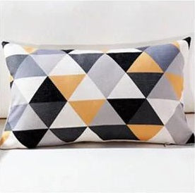 Rectangular cushion cover with black, grey, white and muted yellow triangles.