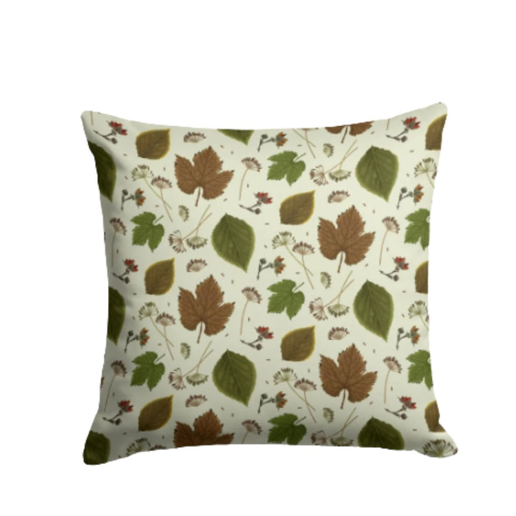 Cream cushion cover with small green and brown leaf silhouettes.