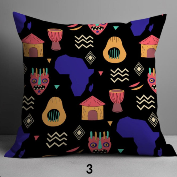 Black cushion cover with colourful masks, pots, drums and map silhouettes.