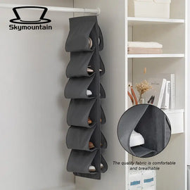 Grey hanging shoe organizer with a close-up of its fabric pocket.