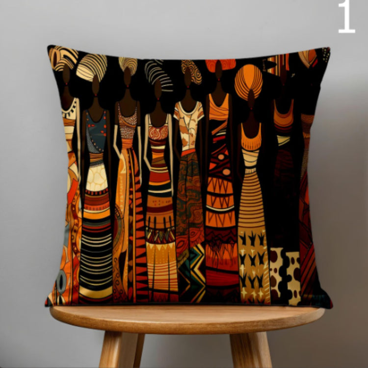 Black cushion cover with a row of tall figures in warm patterned clothing.
