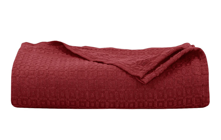 Folded burgundy cotton thermal blanket.