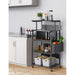 Black rolling kitchen rack holding a microwave, jars, produce and storage boxes
