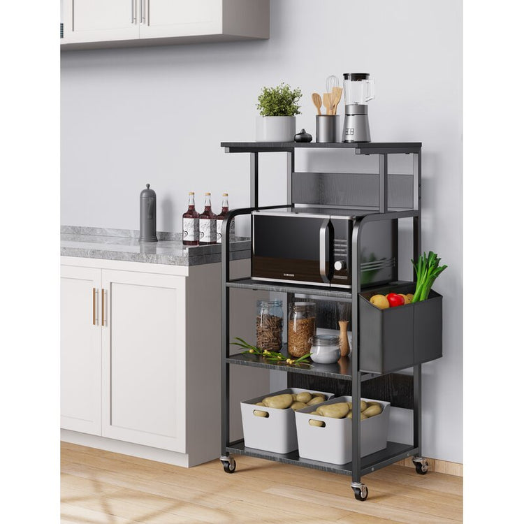 Black rolling kitchen rack holding a microwave, jars, produce and storage boxes