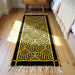 Yellow and black patterned rug on a wooden floor with a wooden nightstand and bed in the background.